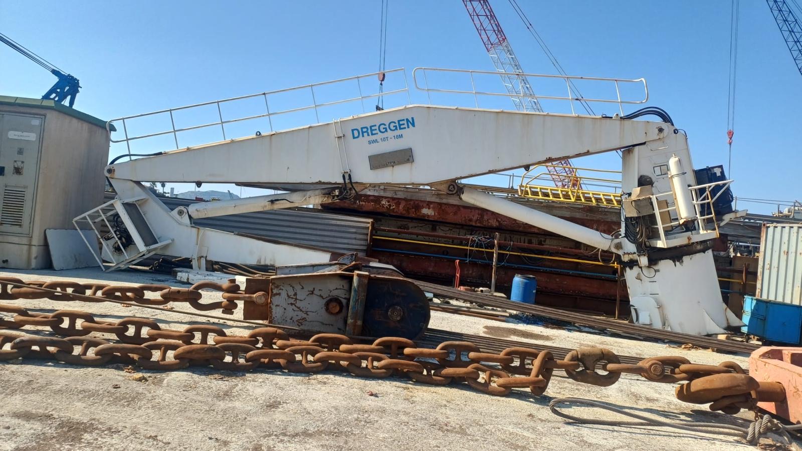 Low-angle view of crane laid down at the yard
